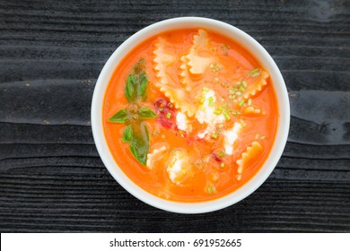 Creamy Cheese Tomato Lasagna Soup On Black Rustic Background, Top View, Overhead, Copy Space