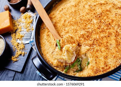 Creamy And Cheesy Potato And Green Bean Casserole With Bread Crumbs Topping In A Black Dish,  Horizontal View From Above