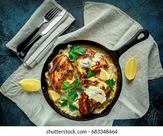 Creamy chicken fellets supremes in mushroom sauce with parsley In rustic cast iron skillet. - Powered by Shutterstock