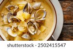 Creamy Clam Chowder, rich with tender clams and hearty potatoes. A comforting and classic soup, perfect for warming up.
