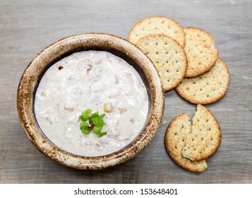 A Creamy Crab, Potato And Corn Chowder With Scallions And Pepper Flakes With Crackers On The Side.