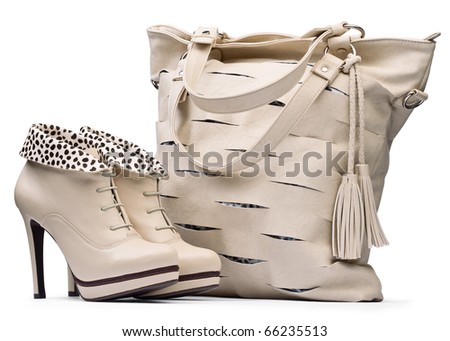 Creamy female high-heeled boots and leather bag isolated on white background. with path
