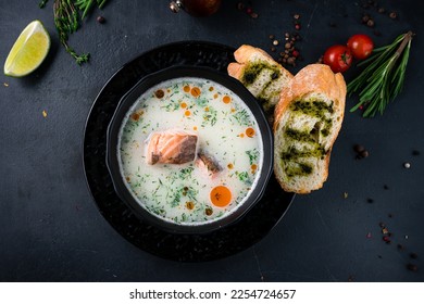 Creamy fish soup with salmon, potatoes, onions , carrots, dill and celery . Kalakeitto- traditional dish of the Finnish cuisine or Russian Ukha fish soup Top view. - Shutterstock ID 2254724657