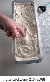 Creamy Ice Cream In A Metal Tray  With A Spoon For Making I've Cream Balls.