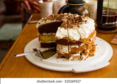 Creamy Layer Cake At A Busy Teatime Table