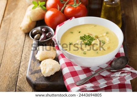 Creamy lemon chicken soup with rice garnished with parsley