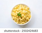 Creamy mac and cheese in a bowl, isolated on white background