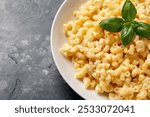 Creamy mac and cheese macaroni in a white bowl.