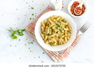 Creamy Macaroni Pasta In A Bowl Garnished With Parsley And Chili Flakes Top Down Photo