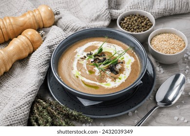 Creamy mushroom cream soup with herbs and spices in a bowl - Powered by Shutterstock