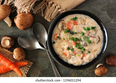 Creamy Mushroom Soup. Autumn Food Concept. Above View Scene On A Dark Slate Background.