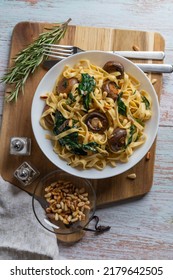 Creamy Mushroom Spinach Pasta. Rustic Pasta With Mushrooms, Creamy Spinach Sauce And Parsley On A Wooden Background, Vertical