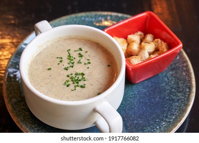 Creamy Onion Soup With Green. Health Food At Cafe. Classic Cuisine. Cooking Bowl With Bread Croutons. Yam Dish. Hot Vegetable Plate