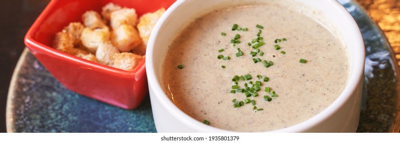 Creamy Onion Soup With Green. Health Food At Cafe. Classic Cuisine. Cooking Bowl With Bread Croutons. Yam Dish. Hot Vegetable Plate. Horizontal Banner. Copyspace