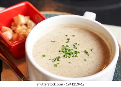 Creamy Onion Soup With Green. Health Food At Cafe. Classic Cuisine. Cooking Bowl With Bread Croutons. Yam Dish. Hot Vegetable Plate