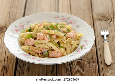 Creamy Pasta With Salmon And Parsley In White Plate