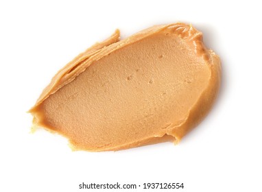Creamy peanut butter isolated on white background. Top view.