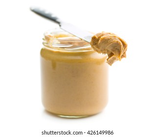 Creamy peanut butter isolated on white background. Spreads peanut butter in the jar.