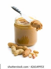 Creamy peanut butter and peanuts  isolated on white background. Spreads peanut butter in the jar.