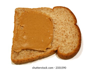 Creamy Peanut Butter Spread On Slice Of Whole Wheat Bread