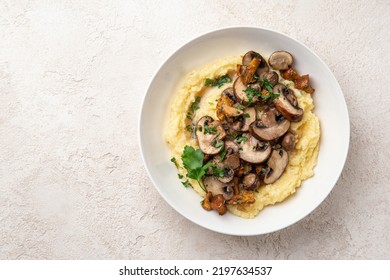 Creamy polenta with fried mushrooms, top view, copy space - Shutterstock ID 2197634537