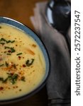 Creamy potato soup with chives and cheese in a bowl