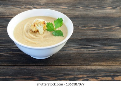 Creamy Roasted Cauliflower Soup On Rustic Table