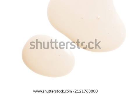 Creamy serum texture. Soft yellow skincare liquid drops. Cosmetic emulsion swatch isolated on white background