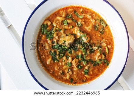 creamy spicy seafood fish soup with coriander herbs