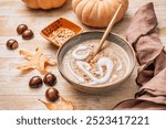 Creamy sweet chestnuts and pumpkin soup with seeds and cream