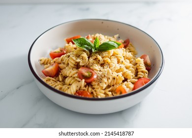 Creamy Vegan Garlic Fusilli Pasta With Cherry Tomatoes And Basil Topping, Healthy Plant-based Food Recipes