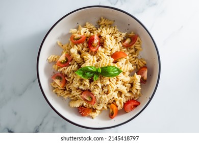 Creamy Vegan Garlic Fusilli Pasta With Cherry Tomatoes And Basil Topping, Healthy Plant-based Food Recipes