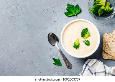 Creamy White Bean Broccoli Soup Puree In A Bowl On Blue Concrete Background. Top View, Space For Text. 