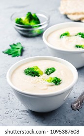 Creamy White Bean Broccoli Soup Puree In A Bowl On Blue Concrete Background. Selective Focus, Space For Text. 