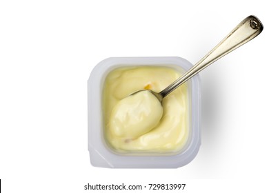 Creamy Yellow Apricot And Peach Yogurt In Little Plastic Cup With Small Silver Spoon - Top View Image Of Fruit Yoghurt In Pot Isolated On White Background