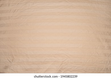 Creased Beige Satin Pillowcase With Horizontal Stripes. Vignette