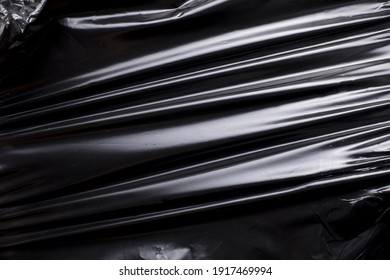 Creased black plastic foil background
