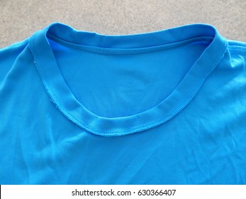 Creased Blue T Shirt Background Texture - Inside Out Showing Neck Stitching And Overlap 