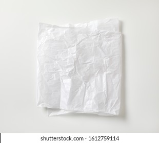 Creased sheet of white wax coated butcher paper