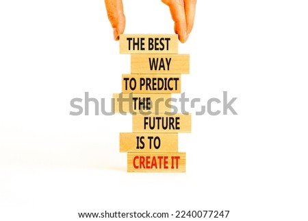 Create future symbol. Concept words The best way to predict the future is to create it on wooden blocks. Beautiful white background copy space. Businessman hand. Business create your future concept.