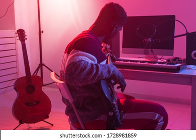 Create Music And A Recording Studio Concept - Black Man Guitarist Recording Electric Bass Guitar Track In Home Studio