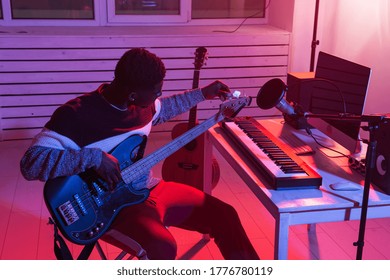 Create Music And A Recording Studio Concept - Black Man Guitarist Recording Electric Bass Guitar Track In Home Studio