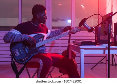 Create Music And A Recording Studio Concept - Black Man Guitarist Recording Electric Bass Guitar Track In Home Studio