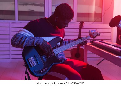 Create Music And A Recording Studio Concept - Black Man Guitarist Recording Electric Bass Guitar Track In Home Studio