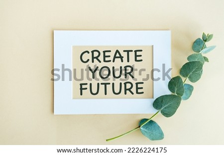 Create Your Future text on white notepad with envelope on yellow background.