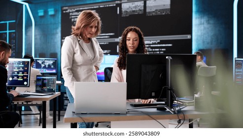 Creating cutting-edge technology in a late-night coding session, diverse team. - Powered by Shutterstock - Get 15% off with code: PIKWIZARD15