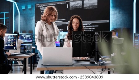 Creating cutting-edge technology in a late-night coding session, diverse team.