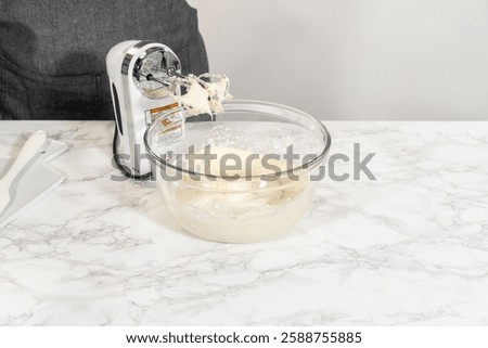 Creating a delectable treat, the process of making homemade cream cheese frosting involves whisking together creamy ingredients to achieve the perfect texture and taste.