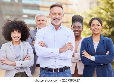 Creating An Impact In The Business World Together. Shot Of A Diverse Group Of Businesspeople Standing Outside On The Balcony With Their Arms Folded.