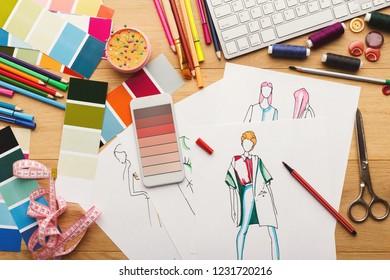 Creating new fashion collection background. Hand drawn sketches of clothes, smartphone with color swatches on screen and threads on wooden table, top view. Creativity, dressmaking and design concept - Powered by Shutterstock